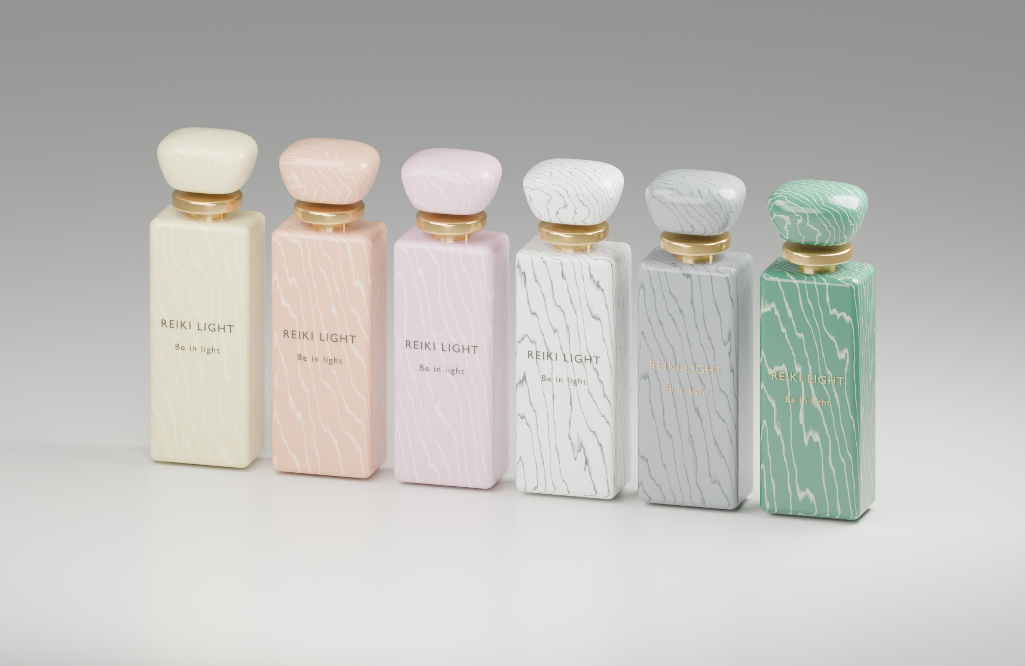 Helios: six Reiki Light marble-pattern perfume bottles in pale yellow, peach, pink, white, grey and green, with gold collars and Be in light lettering.